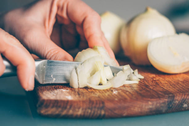 istock The cook cuts the onion on a cutting board 938536952