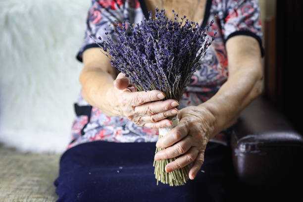 istock elder woman holding bouquet 938540400