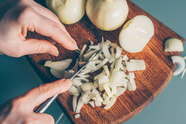 istock The cook cuts the onion on a cutting board 938541902