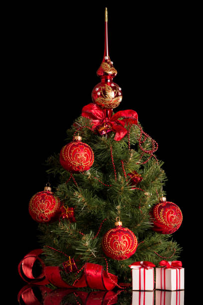istock Christmas tree, beautifully decorated small boxes with gifts, isolated on black 938542872