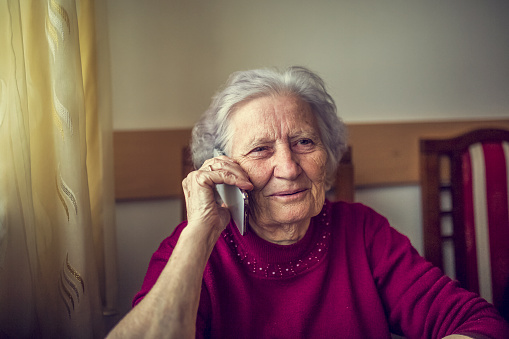 Old senior lady using smart phone