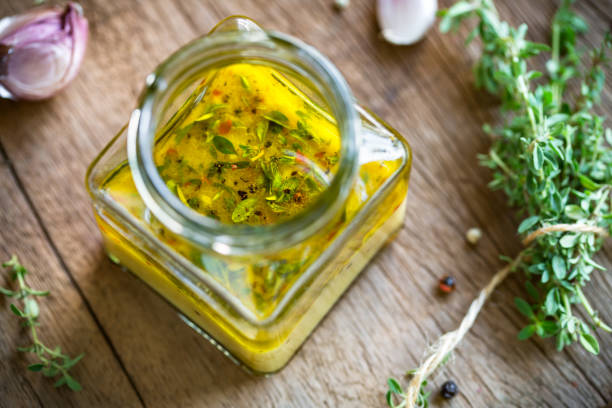 Lemon Vinaigrette with Thyme Lemon Vinaigrette with Thyme by fresh ingrdients cooking with garlic stock pictures, royalty-free photos & images