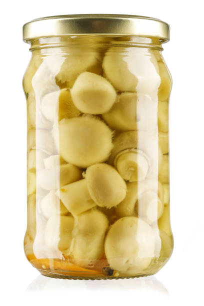 canned mushrooms in jar isolated on white background. Clipping path.