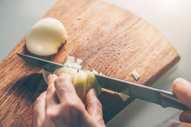 istock The cook cuts the onion on a cutting board 938548414