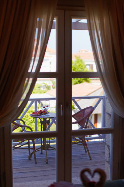 istock Hotel balcony with pool view, vine and fruits served 938549624
