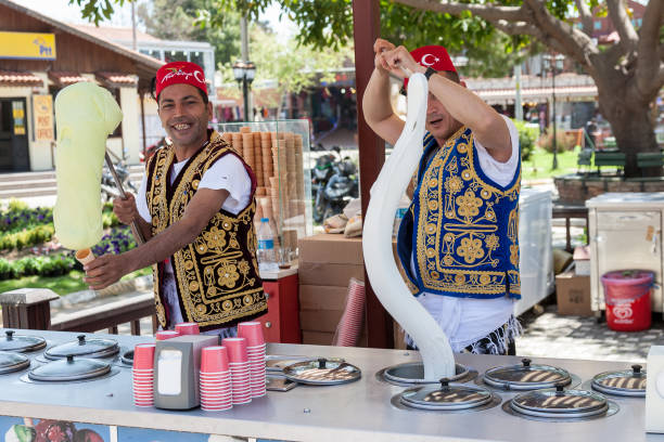 Turkish men selling traditional turkish icecream on a street in Side, Turkey SIDE, TURKEY - april 19, 2012: Turkish men in turk costumes selling traditional turkish icecream on a street in Side, Turkey turkish culture stock pictures, royalty-free photos & images