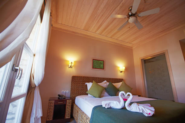 istock Cozy small hotel bedroom decorated for guests 938552364