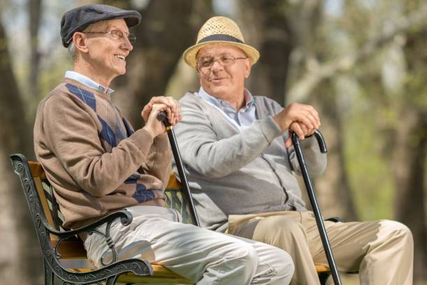 istock Two elderly men seated on a bench outdoors 938554946