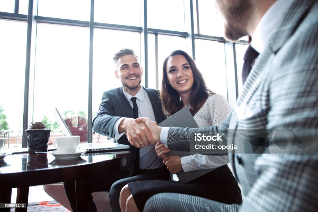 Business people shaking hands, finishing up a meeting. Business people shaking hands, finishing up a meeting Bank - Financial Building Stock Photo