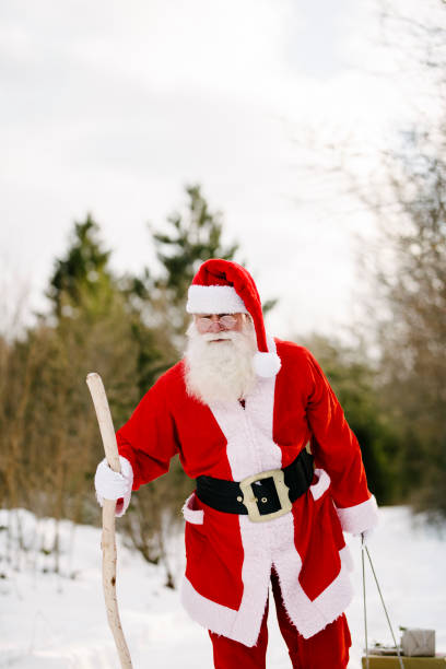 istock Santa Claus with sled and gifts 938568818