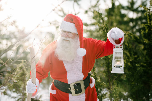 istock Santa Claus with lantern in the sunset 938568840