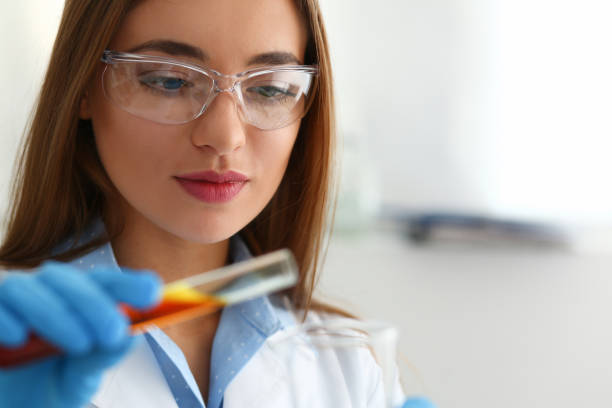 istock Technician hold in arms in protective gloves sample bottle 938573662