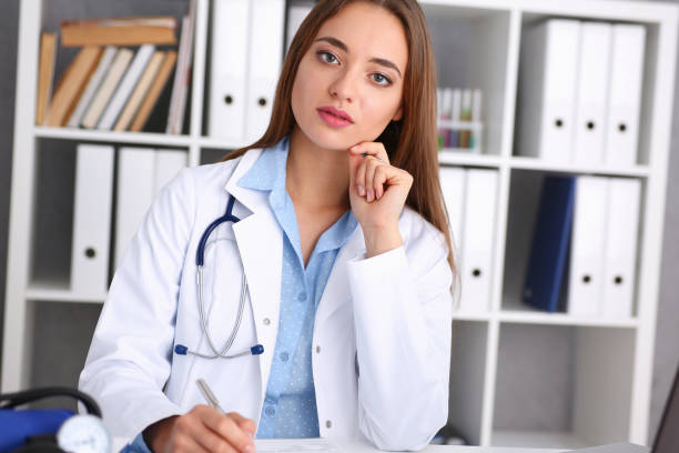 istock Female doctor hold hold in arm silver pen 938574338