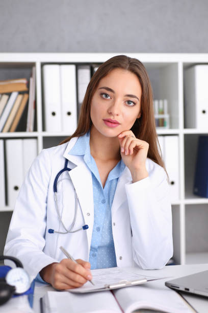 istock Female doctor hold hold in arm silver pen 938574340