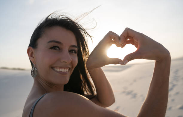 istock Loving woman at the desert making a heart shape 938577418