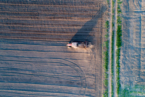 istock Aerial image of tractor working in field 938577490