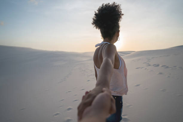 Woman leading the way while traveling in the desert