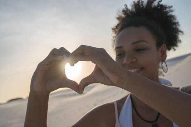 istock Loving woman at the desert making a heart shape 938577816