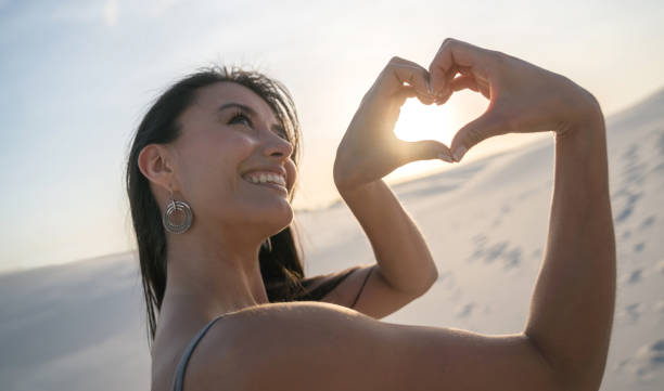 istock Thoughtful loving woman at the desert making a heart shape 938577912