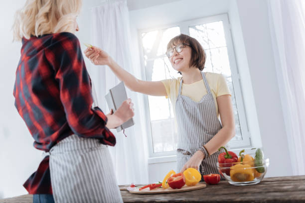 istock Joyful happy woman feeding her girlfriend 938579356
