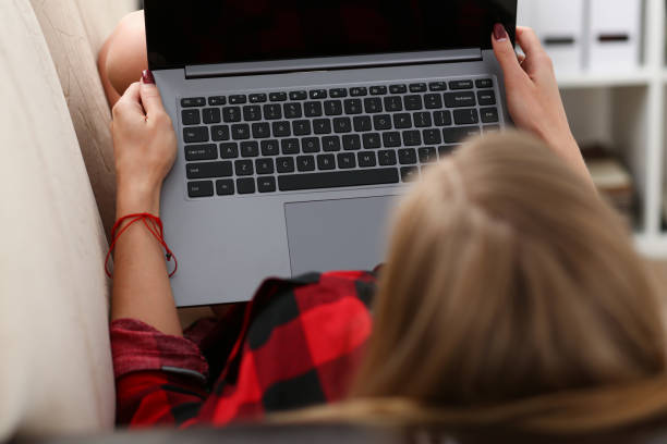 istock young woman hold laptop in arms work 938579402