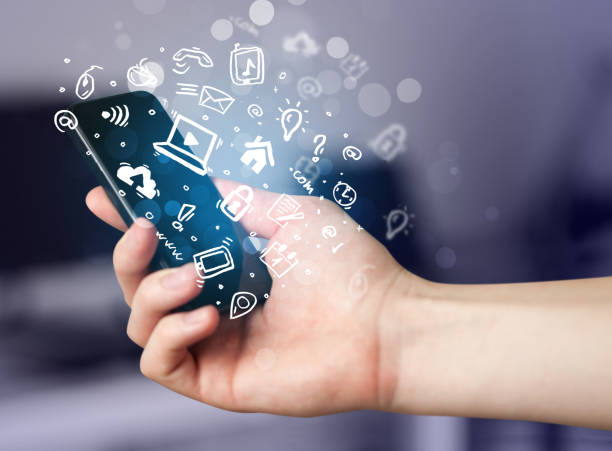 istock Hand holding smartphone with media icons and symbol 938587336