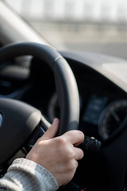 istock Hand holding steering wheel driving car 938593984