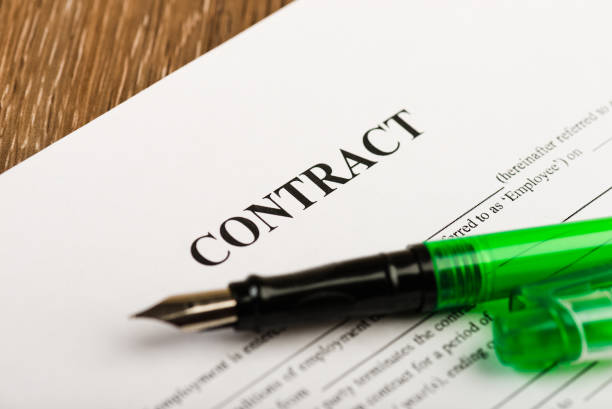 istock Pen and contract papers on wooden desk 938598062
