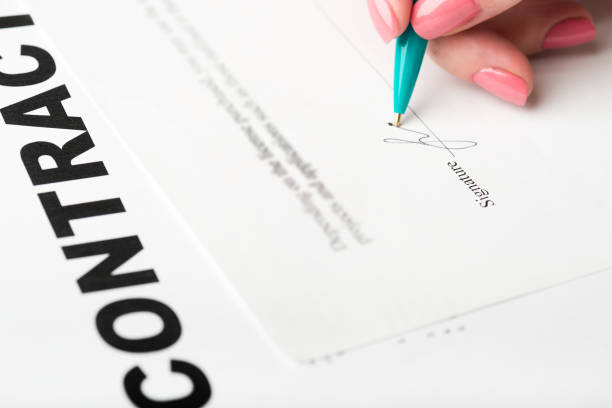 istock female hand signing a contract. 938598220