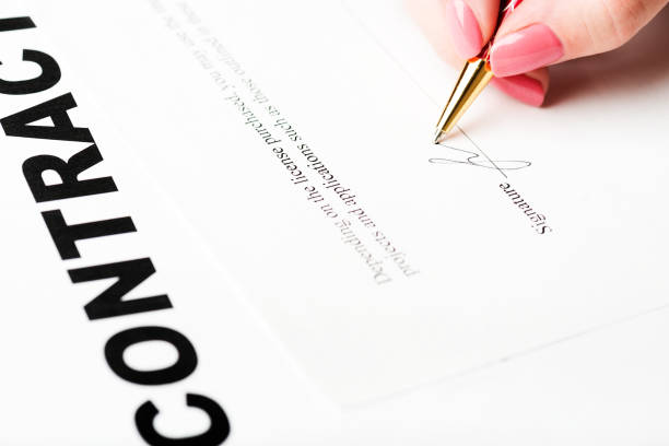 istock female hand signing a contract. 938598236