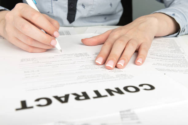 istock Woman hand signing a contract 938598306