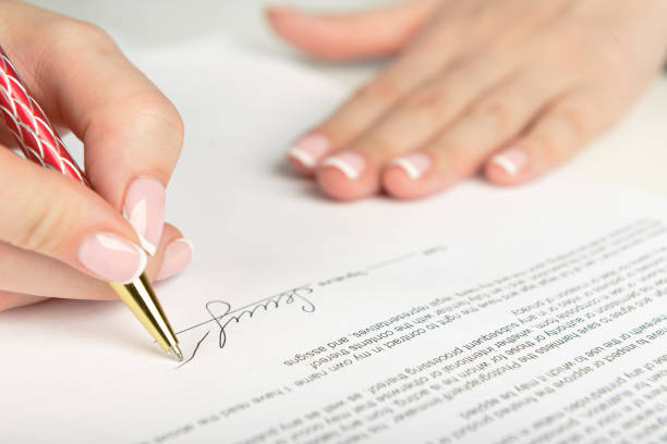 istock Woman hand signing a contract 938598312
