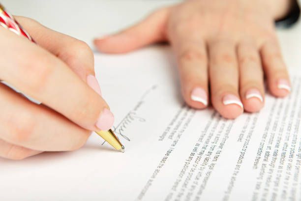 istock Woman hand signing a contract 938598336