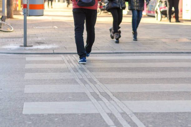 istock People crossing a zebra crossing in a street 938598856