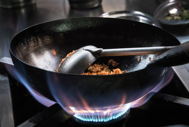 istock Chef frying on the gas stove with fire 938598932