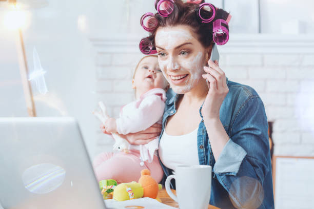 Cheerful delighted woman having a phone conversation