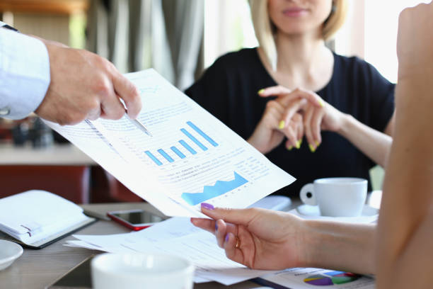 istock businessmen meet in cafe discuss documents 938604878