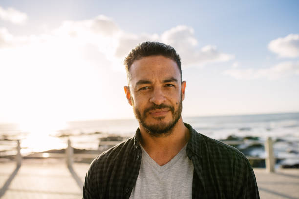 istock Man on vacation standing near the sea 938604932