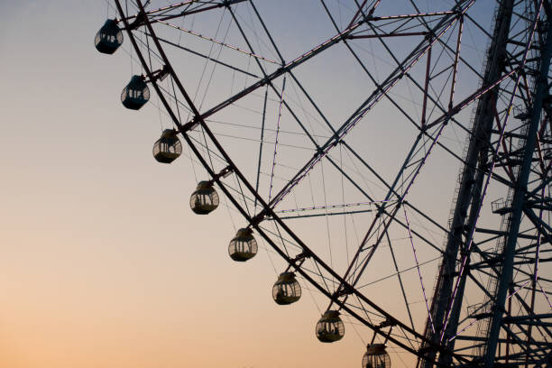 istock Ferris wheel silhouette against the sunset to use as background. 938611322