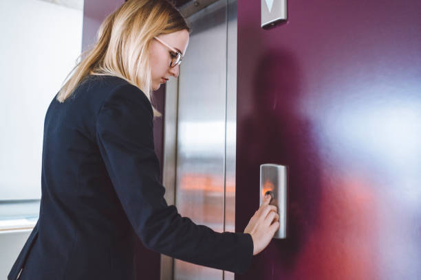 istock Businesswoman waiting for elevator 938614114