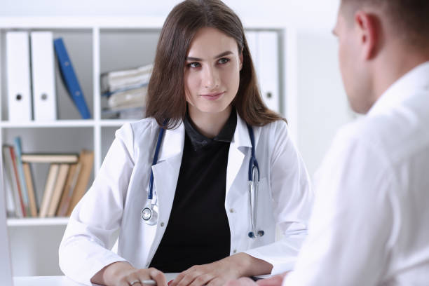 istock Beautiful smiling female doctor hold silver pen 938614458