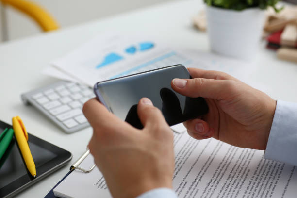 istock A businessman holds a new smartphone in his hand 938614762