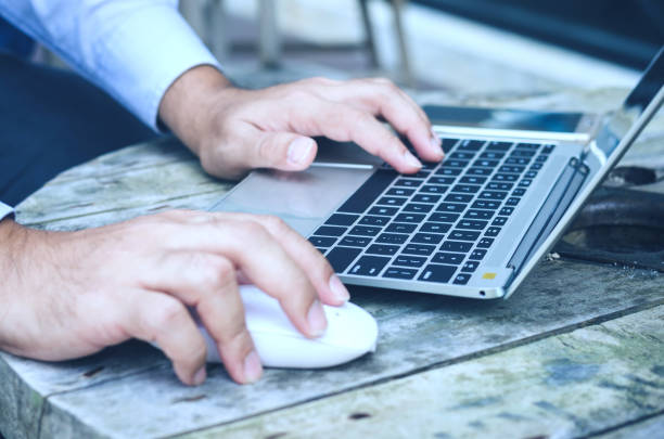 istock laptop working with hands business man clicking on mouse and typing on keyboard. technology computer notebook. 938617122