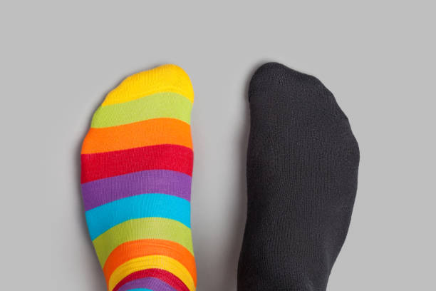 istock Foots in different colors socks on grey background 938619114