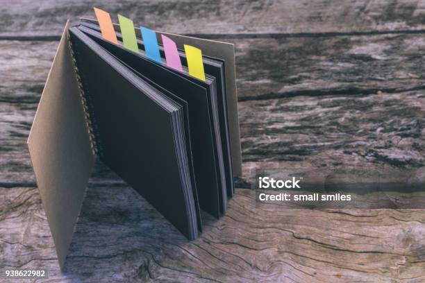 Abstract Sketchbook With Color Note Tab Notebook With Colors Note Tab On Wooden Table Background Vintage Picture Tone Stock Photo - Download Image Now