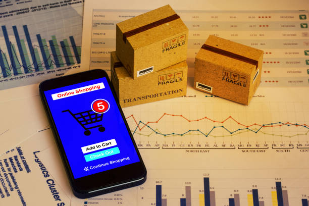 istock Smartphone runs an online shopping app with cardboard boxes. concept about this type of financial charts include stacks of bar compare between the expansion of export business for goods each year. 938626766