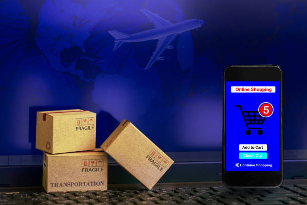 istock Smartphone runs an online shopping app with cardboard boxes on notebook keyboard. concept about transportation, global shipping, international freight, overseas trade, regional, services remotely. 938627242