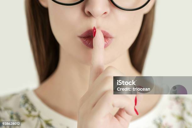 Finger On Lips Silent Gesture Stock Photo - Download Image Now - Whispering, Mystery, Privacy