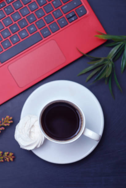 istock Worktable with Laptop, Cup of Coffee, Green Leaves. Dark blue, Toned Table. Flat Lay. 938628440