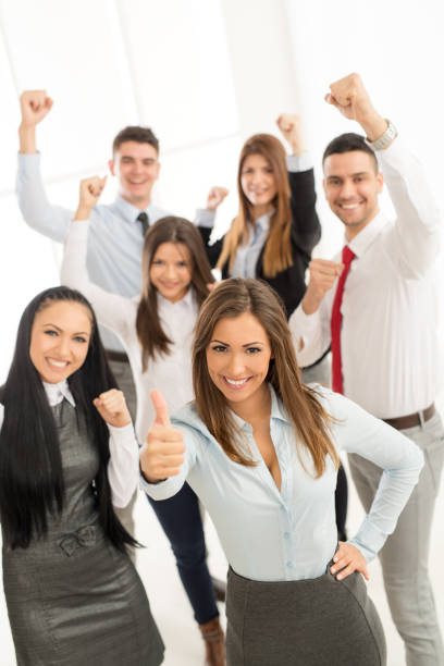 Group of business people jumping in the air to get a mobil phone.